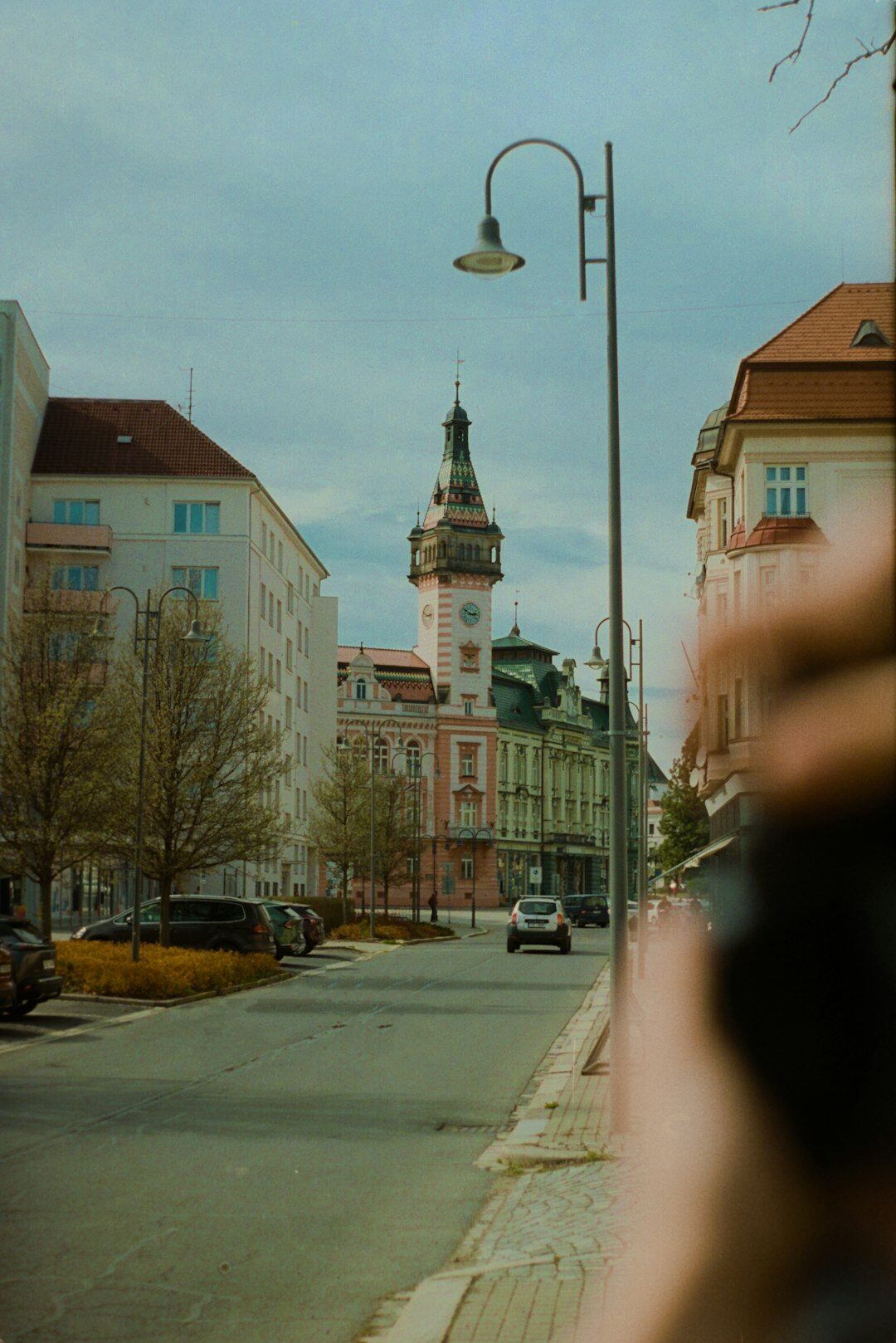Camera mounted on a handheld gimbal stabilizer with a city street in the background