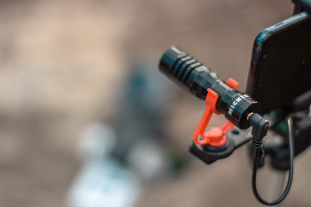 Professional shotgun microphone mounted on a camera rig with a portable audio recorder